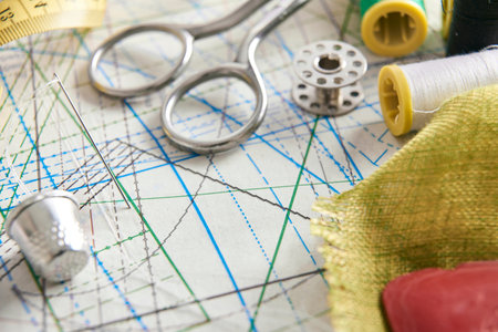 Tailoring tools on clothing pattern.  Horizontal composition. Elevated view