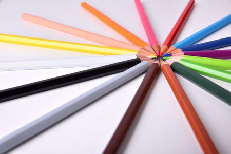 Background with gradient color pencils placed on circle on white table. Elevated viewの写真素材