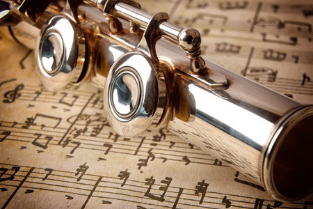 Rear of flute on old handwritten sheet music close up. Horizontal composition. Elevated viewの写真素材