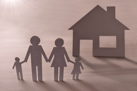 Concept of house and family in paper on wood. Horizontal composition. Elevated view.の写真素材