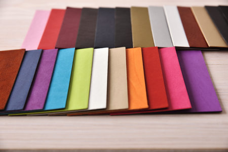 Materials textures and color cards for interior decoration. Fabric and leather samples on wood table. Front elevated viewの写真素材