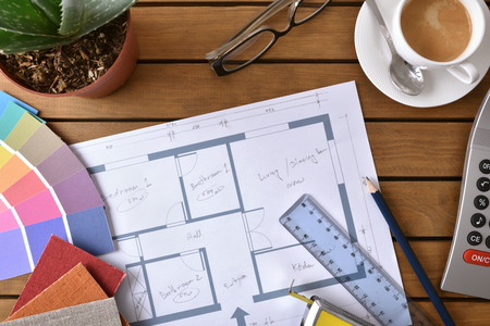Wood table with a house plan, tools and samples of a decorator designer. Top viewの写真素材