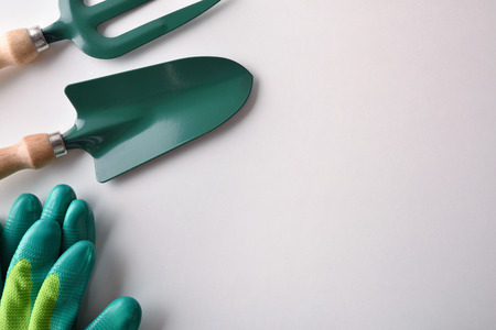 Gardening tools for trees, plants and flowers on white table. Top view. Vertical compositionの写真素材