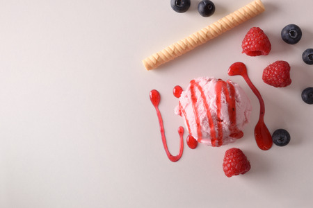 Ice cream flavored berries texture background with ball isolated on white table. Garnished with  Top view. Horizontal composition.の写真素材