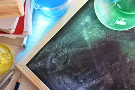 Classroom desk and blackboard of chemistry teaching with books and instruments. Chemical sciences...