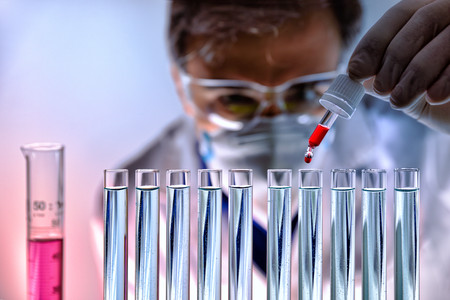 Chemical equipped with protective elements analyzing different substances in the laboratory. Front viewの写真素材