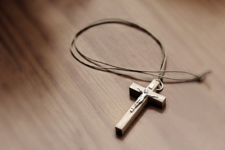 Closeup of crucifix on a wooden table. Elevated viewの写真素材