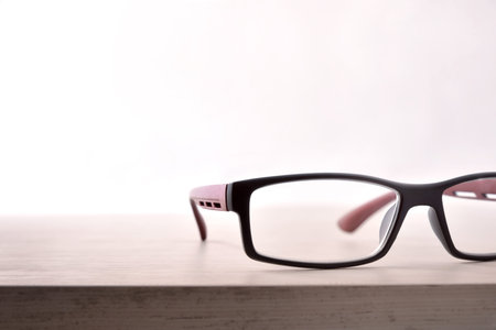 Eyewear on wood table and white background front view detail. Front view. Horizontal composition