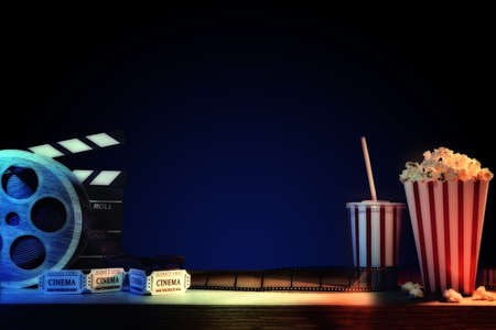 Equipment and elements of cinema on wooden table and dark blue background. Concept of watching movies. Horizontal composition. Front view.の写真素材