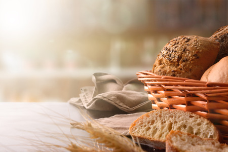 Bread on basket on fabric and black wooden table. Front view. Horizontal compositionの写真素材