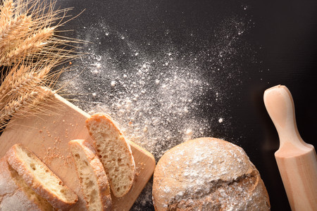 Loaf and slices homemade on black table. Top view. Horizontal compositionの写真素材