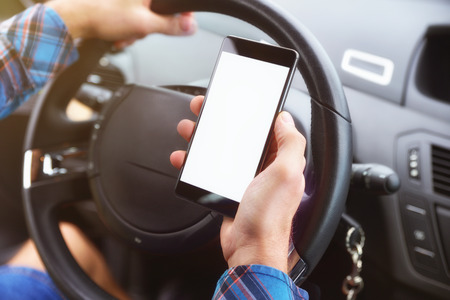 Consulting a phone  driving a car dangerouslyの写真素材