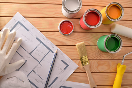 Colored paint for renovation in homes on wooden slatted table. Home diy concept. Top view....