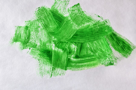 Green paint background made with brush on white paper. Horizontal compositionの写真素材