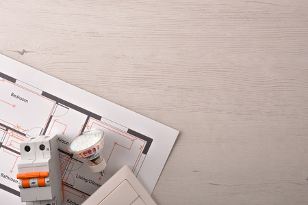 Equipment on white wooden table for electrical installation of housing close up. Horizontal composition. Top view.の写真素材