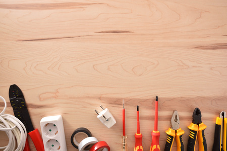Variety of electricity tools on a wooden table with space above. Horizontal composition. Top view.の写真素材