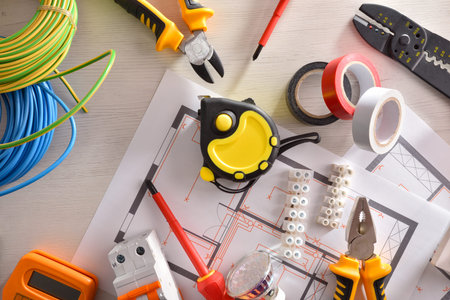 General view of equipment on white wooden table for electrical installation of housing. Horizontal...