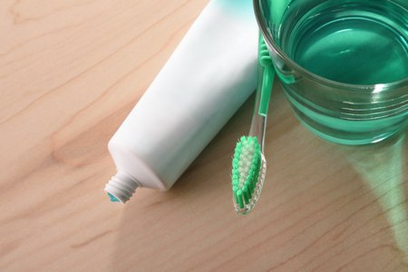 Concept oral hygiene on wood table in bathroom at home with window in the background. Horizontal composition. Top view.の写真素材