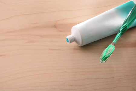 Toothbrush and  toothpaste on wood table dental hygiene concept. Horizontal composition. Elevated view.の写真素材