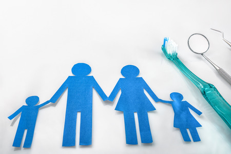 Professional family concept dentist with tools on white table. Horizontal composition. Elevated viewの写真素材