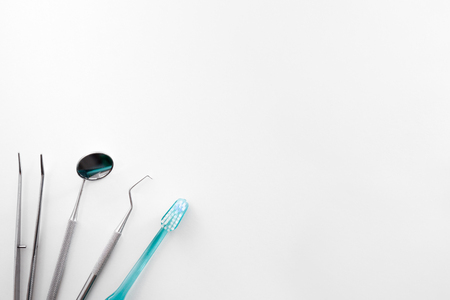 Professional family concept dentist with tools on white table. Horizontal composition. Top viewの写真素材