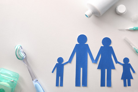 Concept of oral hygiene for the family with tools and products on white table. Horizontal composition. Top viewの写真素材