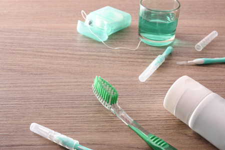 Concept of teeth cleaning at home with tools on wooden table . Horizontal composition. Elevated viewの写真素材