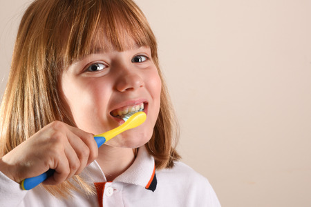 Little girl cleaning her teeth close up. Horizontal composition.の写真素材