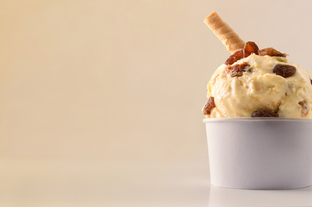 Raisins ice cream cup on table isolated close up. Horizontal composition. Front view.の写真素材