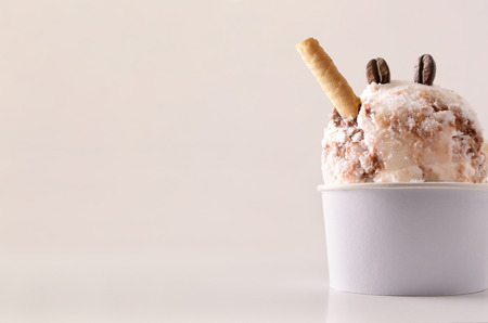 Coffee ice cream cup on table isolated close up. Horizontal composition. Front view.の写真素材