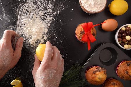 Making chocolate muffins for celebrations with hands and kitchen utensils and products for the...