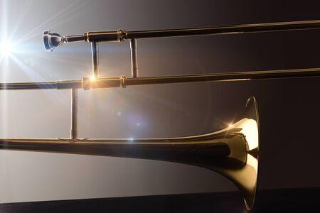 Backlit trombone on black base trombone concert concept with lights and dark background. Side view. Horizontal composition.の写真素材