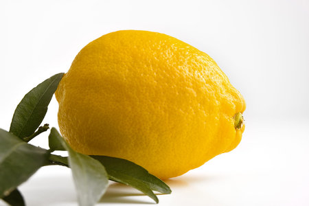 Lemon piece on white base and white isolated background. Horizontal composition.