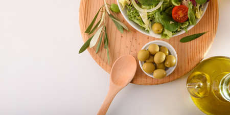 Mediterranean salad with fresh products and olive oil on a white kitchen bench. Top view. Horizontal compositon.の写真素材