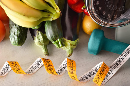 Sports items equipment and healthy food on wooden table for health care, weight loss and healthy life. Elevated view. Horizontal composition.の写真素材