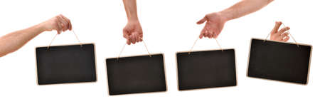 Set of four hands picking up hanging blackboard signs by pita rope in different positions with white isolated backgroundの写真素材