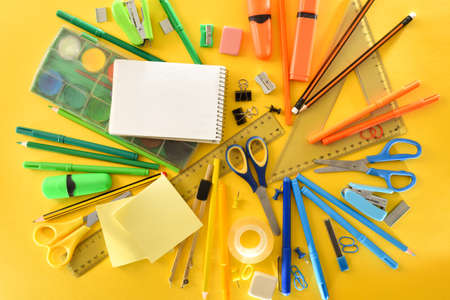 Pile of school supplies on yellow background. Top view. Horizontal composition.の写真素材