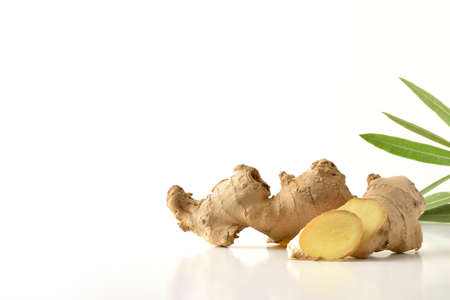 Ginger beverage on wooden table and teapot and leaves. Elevated view.の写真素材