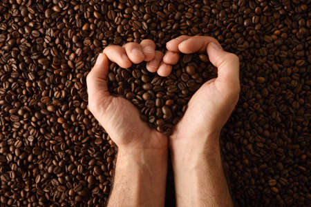 Background with heap of natural dry coffee beans close up. Top view. Horizontal composition.の写真素材