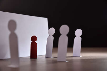 Concept of abuse with cutouts of schoolchildren with young people cornering a child against a wallの写真素材