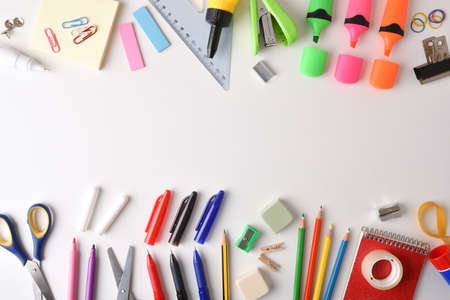 Assortment of colorful school supplies arranged on white table. Top view. Landscape composition.の写真素材