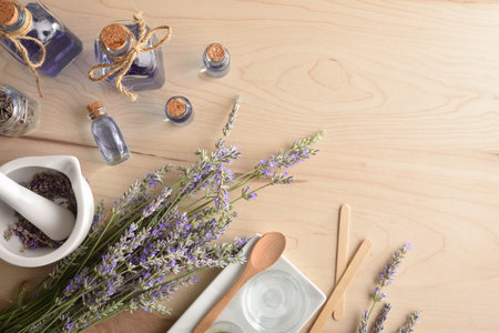 Homemade natural lavender essence with jars and spikes and tools for brewing on wooden table. Top view.の写真素材