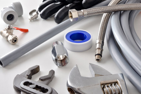 Group of plumbing materials and tools on white workbench. Elevated view. Landscape composition.の写真素材
