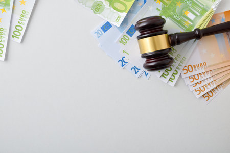 Concept of financial judgment with judge's gavel on heap of banknotes. top viewの写真素材