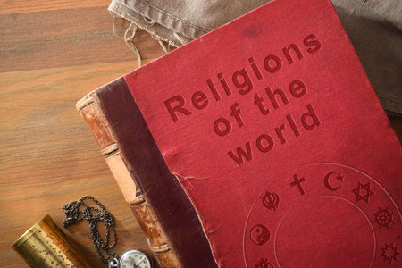 Detail of old book of the study of religions in the world with engraved text and symbols of various...
