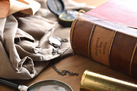 Old and deteriorated book of the religions of the world with ancient objects of study and adventure...
