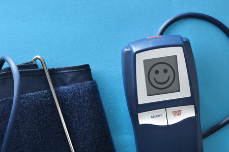 Detail of good health concept of blood pressure with digital blood pressure monitor with smiling...
