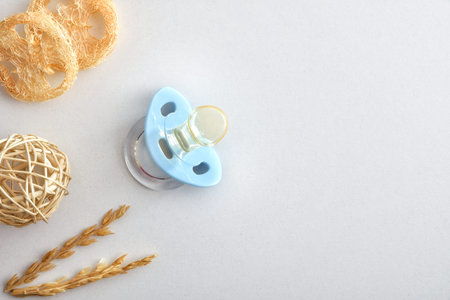 Male baby birth background with blue pacifier and decoration isolated on white background. Top view.
