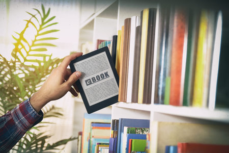 Detail of hand choosing an ebook from a white shelf full of books. Front view.