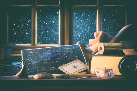 Astrological background of status and forecast with maps with constellations on wooden table with vintage objects and tools around and wooden window behind with starry sky in background. Front view.の写真素材